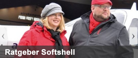 Ratgeber Softshell – Mann und Frau in Softshelljacken vor einem Flugzeug