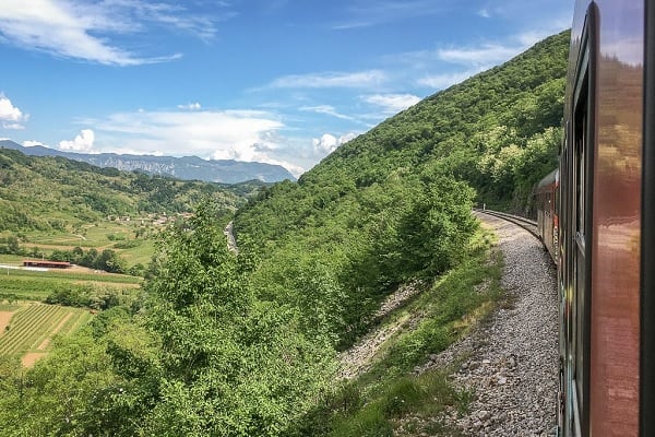 Zug fährt durch schöne Landschaft
